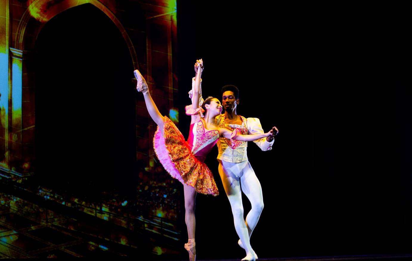 Expert ballet couple in candy colored costumes